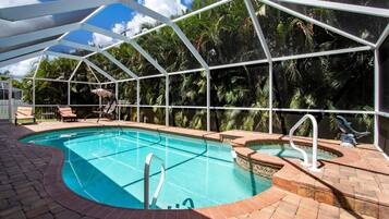 Outdoor pool, a heated pool, pool umbrellas, pool loungers