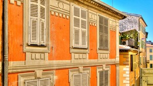 Ein Gebäude mit zahlreichen Fenstern und Fensterläden, das eine große Beschilderung mit 'LLL' an der Fassade aufweist.