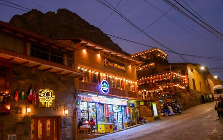 A building with a sign reading "Sol Miranda" and a coffee shop below it.