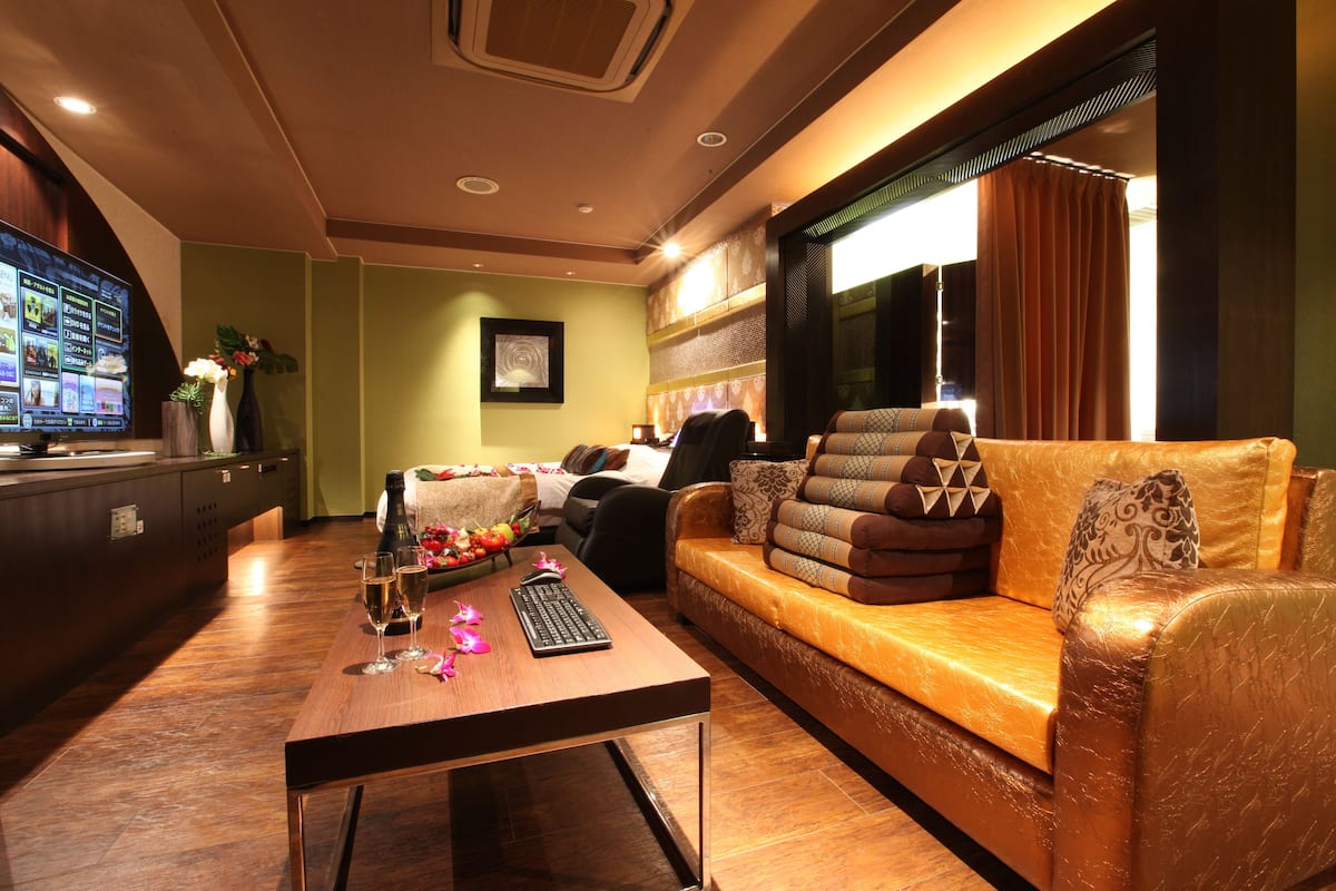 A modern living room with a sofa, a coffee table, and a flat-screen TV.
