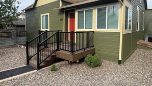 A single-story house with a front porch, a red door, and a number '223' on the wall. - Downtown Historic Charm with Modern Comfort (Prescott)