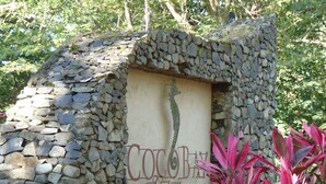 A stone wall with a sign that reads "Coco Bay Villas". - Beautiful Penthouse Condo with stunning views that occupies whole floor (Coco)