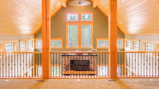 A spacious room with a high ceiling, wooden beams, and a fireplace. - SPACIOUS RETREAT NEAR YELLOWSTONE. FISHING, BOATING, HIKING, ATV & SNOWMOBILING (Island Park)