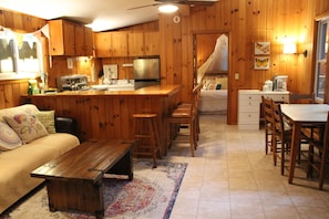 Open concept dining area with twin trundle bed in center.