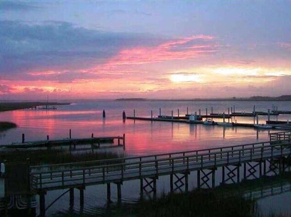 Enjoy serene waterfront views from the pier, where boats bob gently in the calm water.