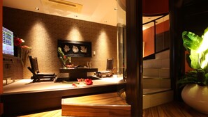 A modern reception area with a wooden reception desk, a framed artwork on the wall, and a potted plant. - LUSSO CROCE ASIAN RESORT - Adult Only (Yokohama)