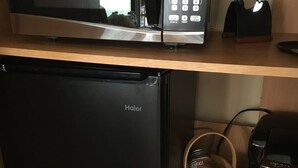 A kitchen with a microwave, a Haier refrigerator, a coffee maker, and a coffee cup. - Beautiful Mountain views with private balcony close to Asheville, NC (Barnardsville)