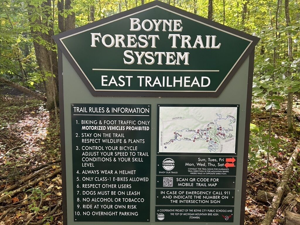 A trailhead sign for the Boyne Forest Trail System East Trailhead with trail rules and a map.