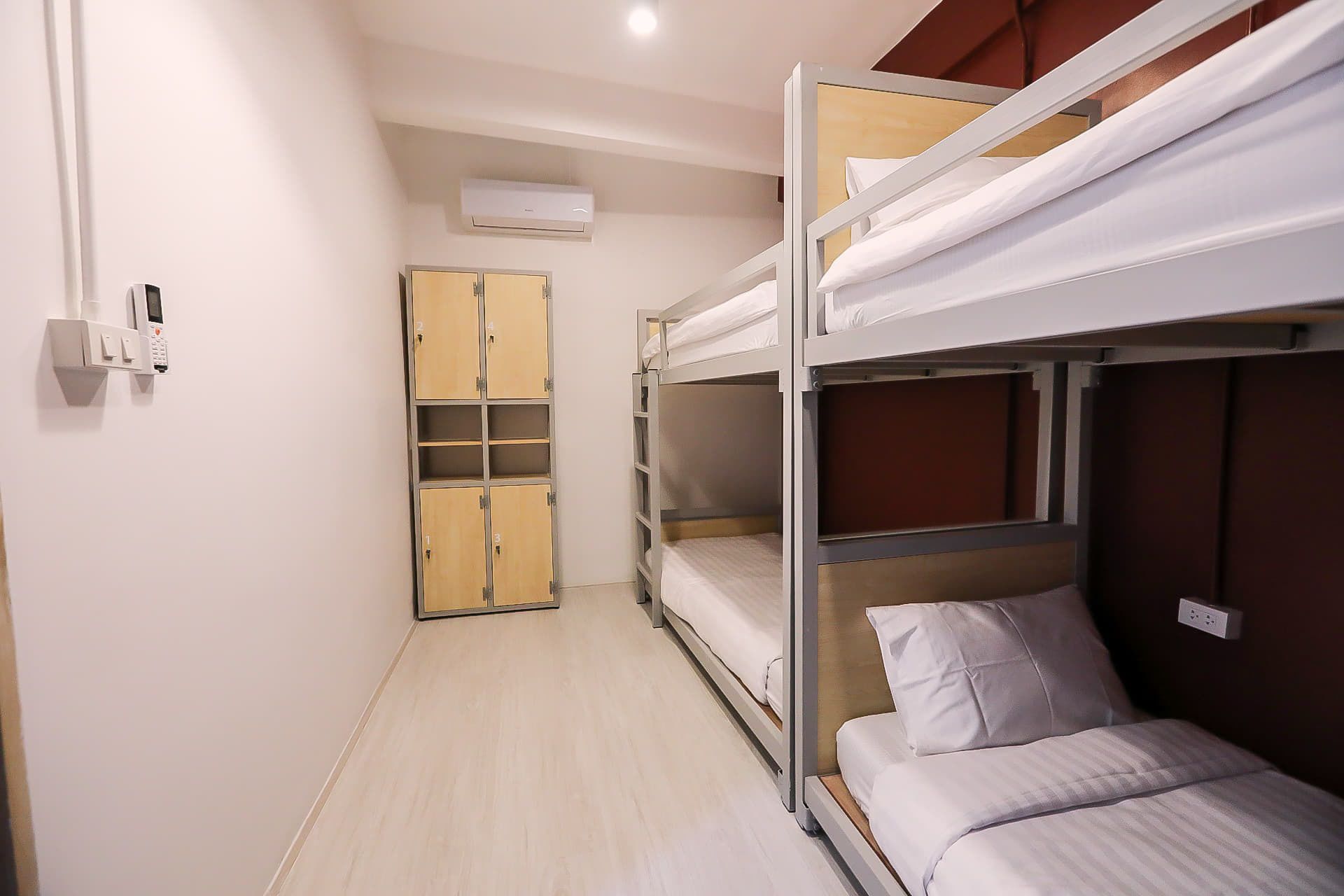 A bunk bed room with a wardrobe and a microwave.
