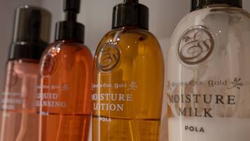 Four bottles of lotion with labels "Moisture Lotion" and "Moisture Milk" in different colors.