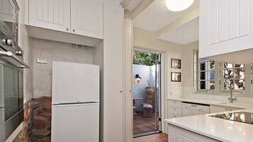 Stylish Beach Apartment, 3 Bedrooms | Private kitchen | Full-sized fridge, microwave, oven, stovetop