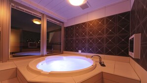 A modern bathroom with a freestanding bathtub, a large mirror, and a geometric-patterned wall. - HOTEL IRIS - Adult Only (Fujisawa)