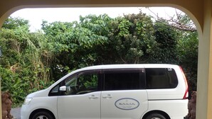 A white van parked in a driveway with a logo on the side. - MaYaGuSuKu RESORT (Taketomi)