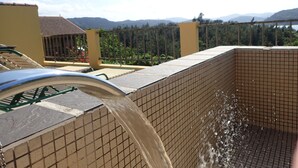 A swimming pool with a tiled interior and a metal faucet. - MaYaGuSuKu RESORT (Taketomi)