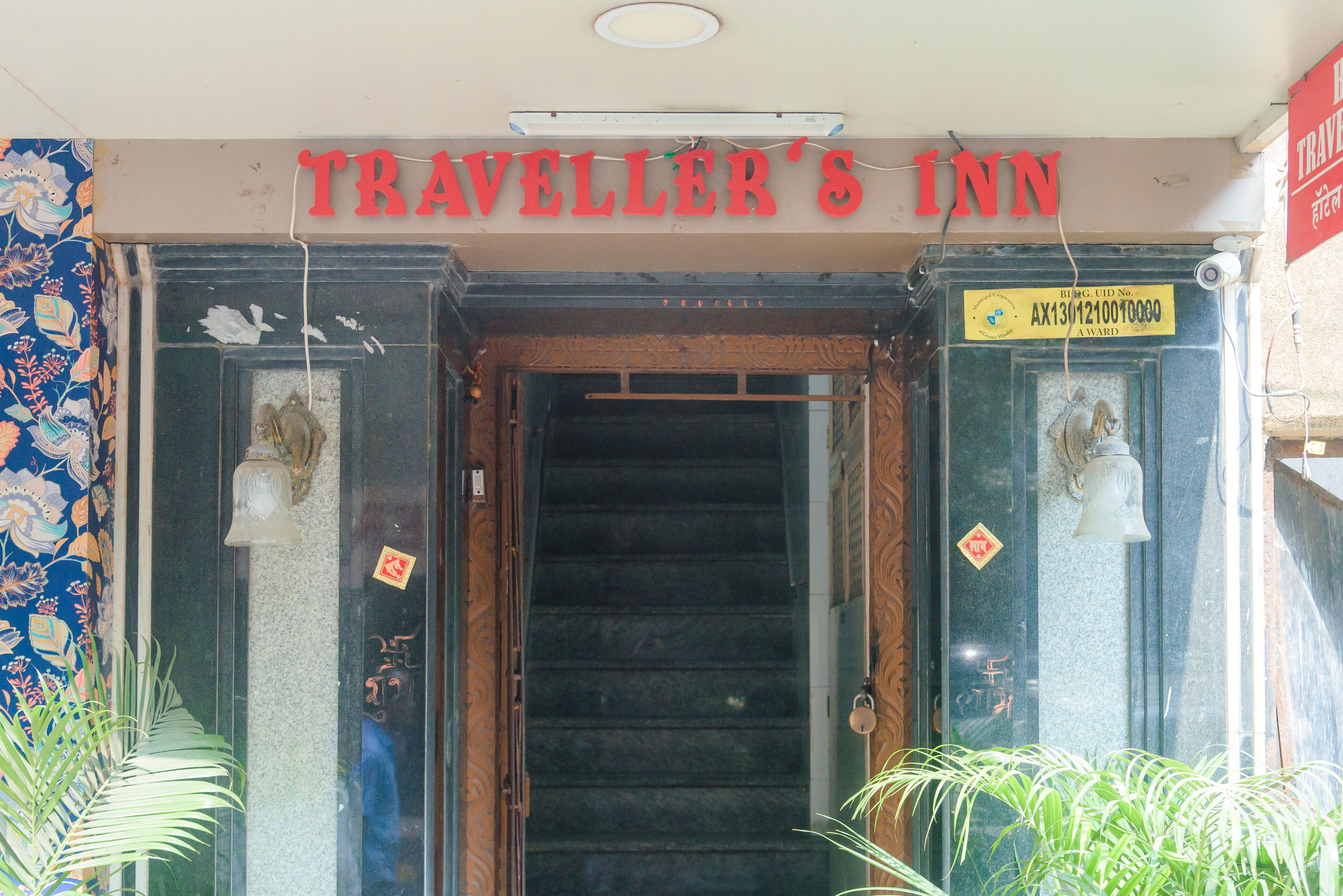 The entrance to Traveller's Inn with a staircase leading inside.
