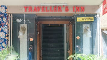 The entrance to Traveller's Inn with a staircase leading inside.