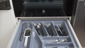 Un tiroir de cuisine ouvert, avec les ustensiles rangés de manière ordonnée.