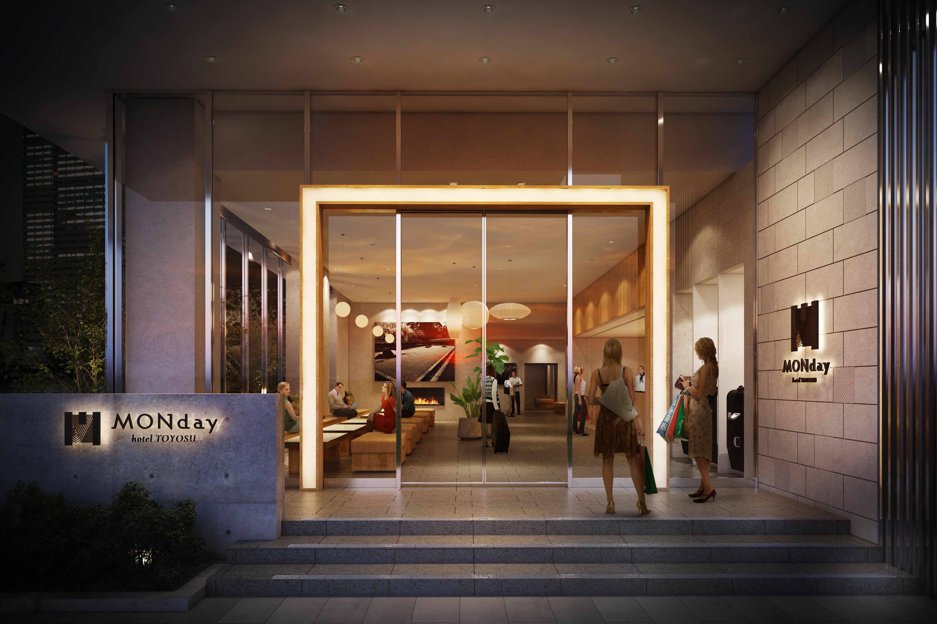 L’extérieur du Monday Hotel se distingue par son design moderne, avec une entrée en verre, un espace salon  à l’intérieur et un foyer apparent.