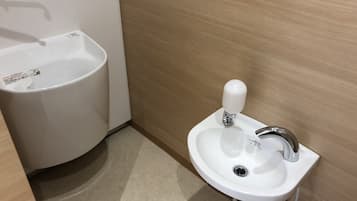 A bathroom with a white sink and a white basin.