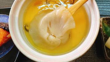 A bowl of soup with a wooden spoon.