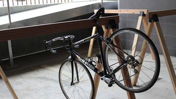A bicycle leaning against a wooden structure in an indoor setting.