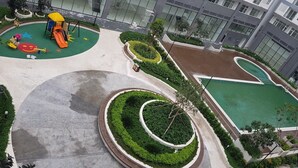 A modern building with a playground, landscaped areas, and a swimming pool. - Florita SGN Green Living (Ho Chi Minh City)