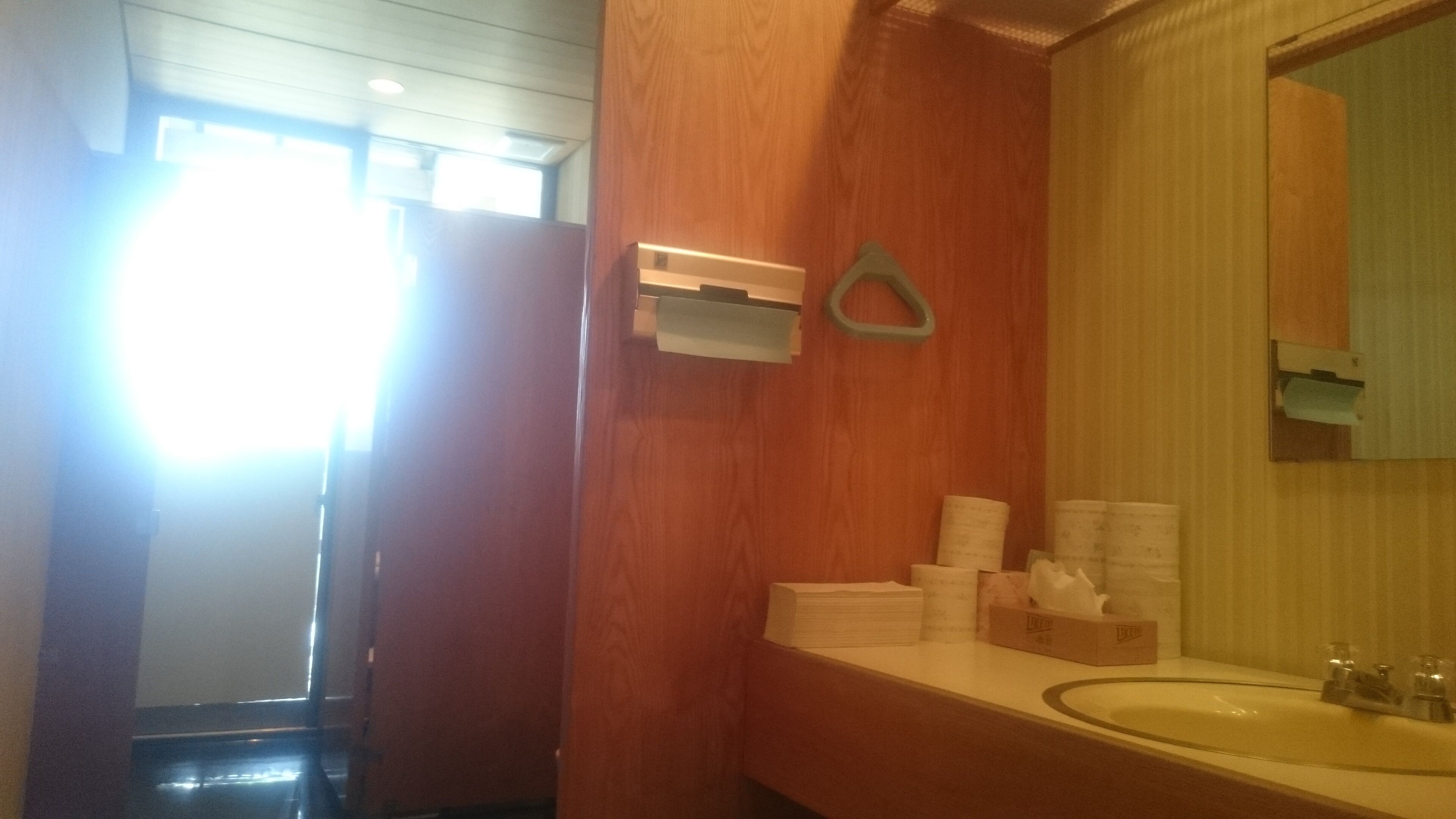 A bathroom with a wooden vanity, a sink, and a mirror.