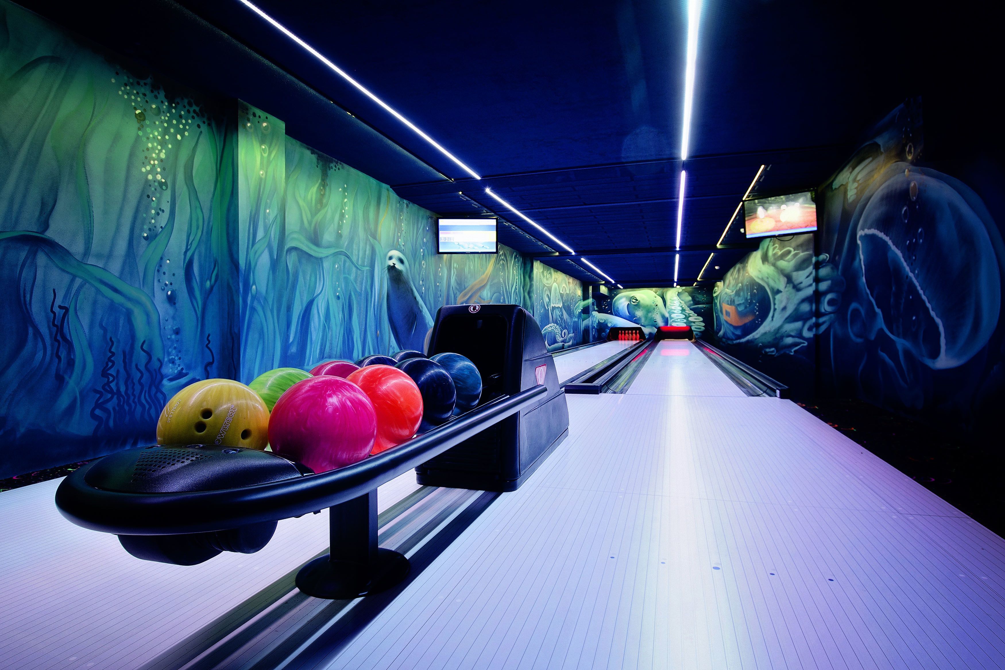 A bowling alley with colorful pins and a modern design.