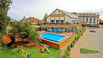 Relax by the pool surrounded by a spacious deck and adjacent play area.