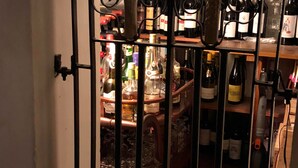 A wine rack with bottles and glasses. - Candlesticks (Stamford)