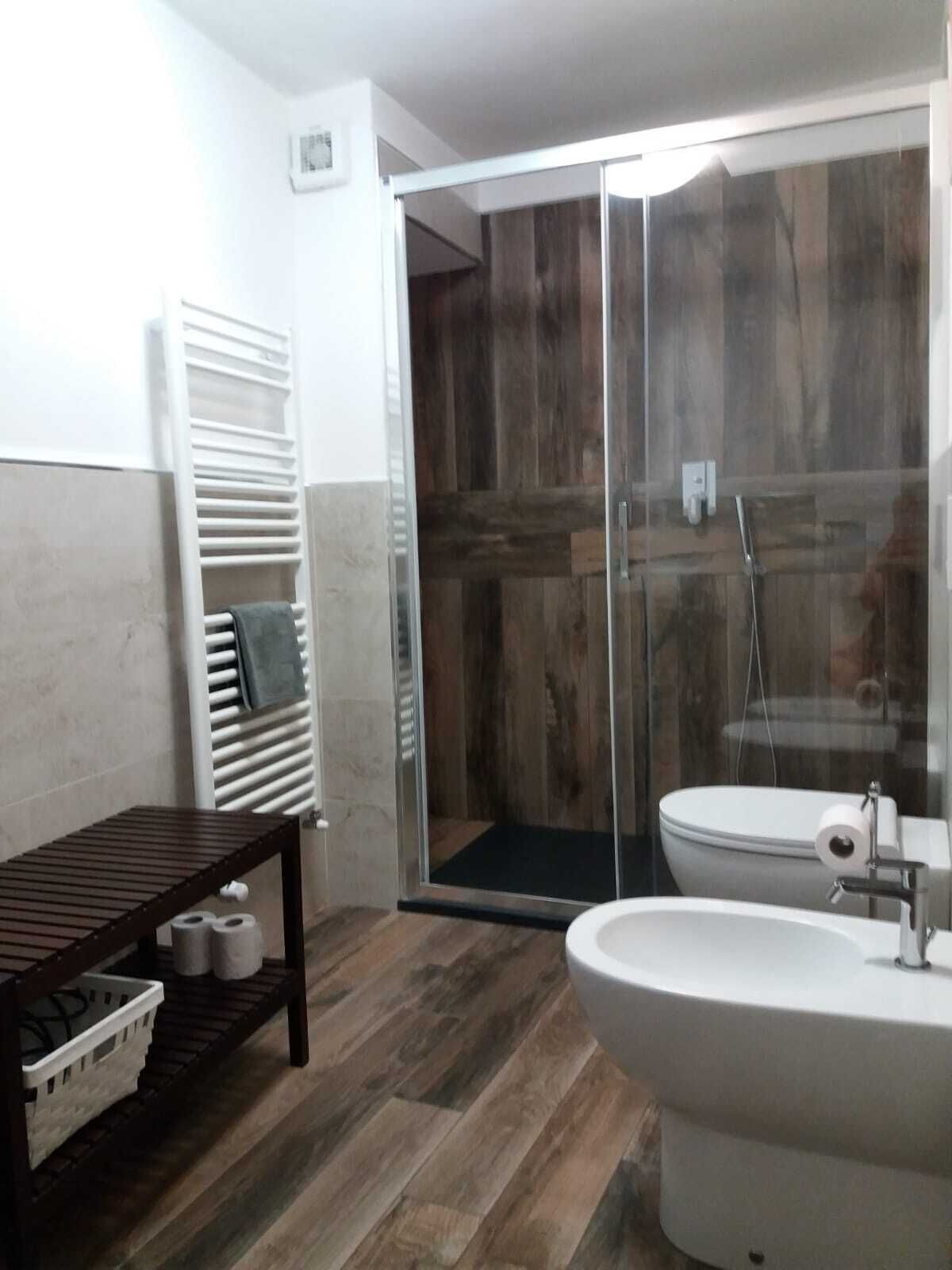 A bathroom with a shower, toilet, and sink.