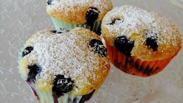 Tres muffins sobre un plato de vidrio transparente.