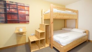 A bunk bed room with a wooden desk and shelving unit. - Black Isle Bar and Rooms (Inverness)