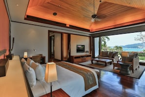 A spacious bedroom with a large bed, a TV, and a view of the ocean. - Villa Chanjar- Kamala Beach (Kamala)