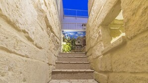 A stone staircase leading to a balcony with a blue railing. - Dimora Corte Antica Scorrano (Scorrano)