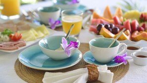 Una escena de desayuno con tazones, platos y una variedad de frutas y bebidas.