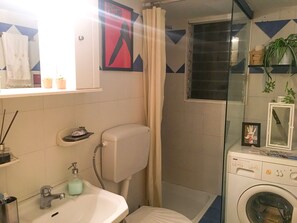 Bathtub, hair dryer, towels, soap