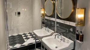 A modern bathroom with two sinks, a glass shower enclosure, and large mirrors with gold frames. - Edgbaston House (Birmingham)