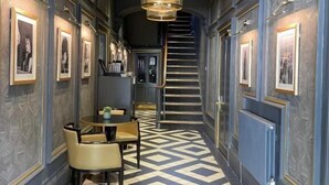 A hallway with a checkered floor, framed pictures on the walls, and a staircase in the background. - Edgbaston House (Birmingham)