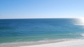 A beach with clear blue water and a sandy shore. - Lighthouse 801 Corner Unit Beachfront w HUGE wrap balcony! Book for Aug., Fall! (Gulf Shores)