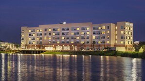 A multi-story hotel with a modern design, featuring a large number of windows and a flat roof.