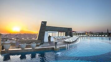 Indoor pool, outdoor pool, pool umbrellas, pool loungers