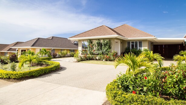 A residential area with multiple houses, paved driveways, and well-maintained gardens. - Ocho Rios Villa Azul at Coolshade XIII (St. Ann's Bay)