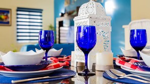 A dining table set with blue glassware, white plates, and a decorative white lantern. - Ocho Rios Villa Azul at Coolshade XIII (St. Ann's Bay)