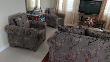 Family Villa, 3 Bedrooms, Garden View | Living room | 50-inch flat-screen TV with cable channels, TV, DVD player