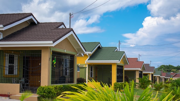 A row of single-story houses with green roofs and a clear sky. - Ocho Rios TaylorMade Vacation Villas (Ocho Rios)