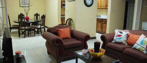 Family Apartment, 2 Bedrooms | Living room | 60-inch flat-screen TV with cable channels, TV, DVD player