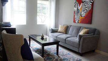 City Apartment | Living room | 50-inch flat-screen TV with cable channels, TV, DVD player