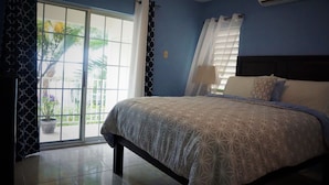 A bedroom with a bed, a window with curtains, and an air conditioning unit. - New Kingston Guest Apt Surbiton (Kingston)