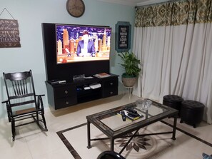 Departamento urbano, 2 habitaciones | Área de sala de estar | Televisión de pantalla plana de 50 pulgadas con canales por cable 